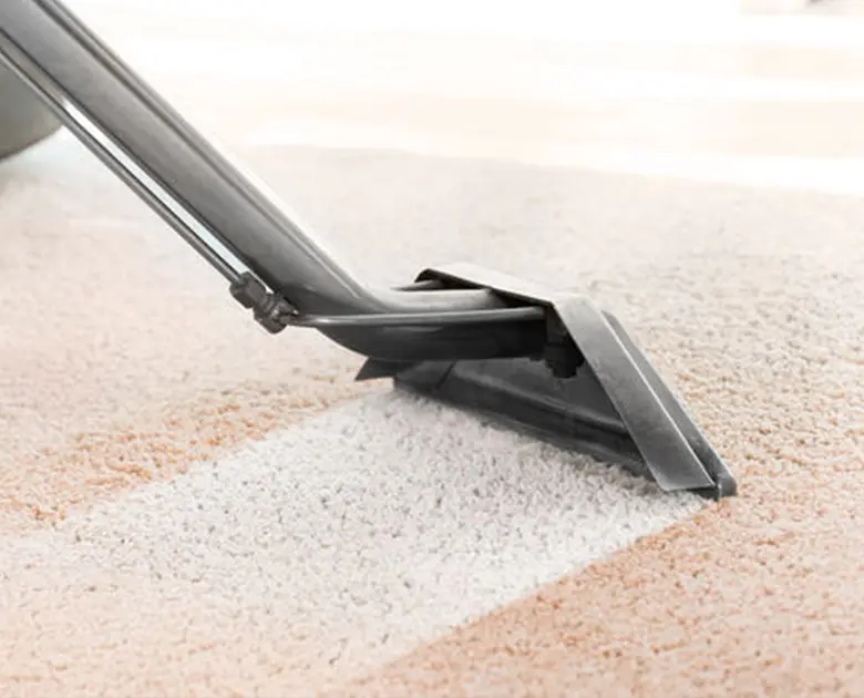 Vacuum cleaning beige carpet closeup